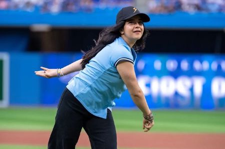 Iman Vellani throwing a ball during a baseball game